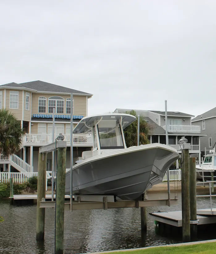 Center-console boat supported on a waterfront lift