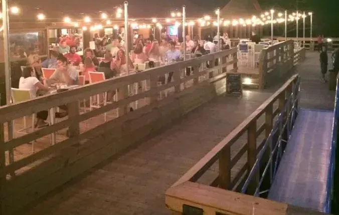 Bovine’s waterfront deck beside the outdoor dining area in the evening