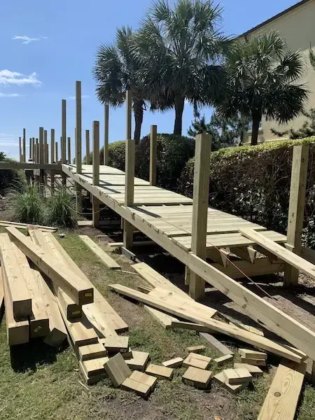 New timber walkway decking and upright posts beside landscaping at Charlestowne Grant