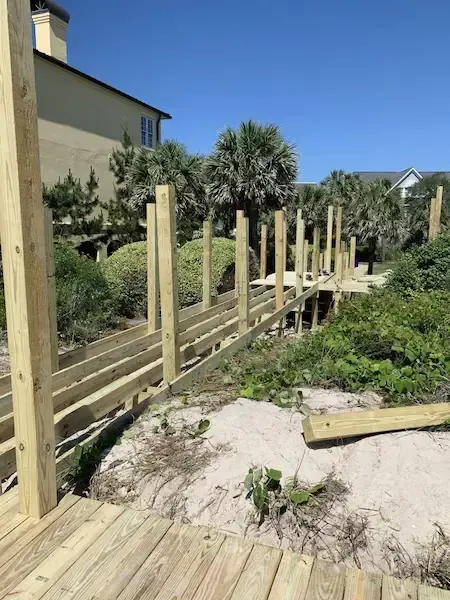 Walkway framing and posts through the dune-side vegetation at Charlestowne Grant