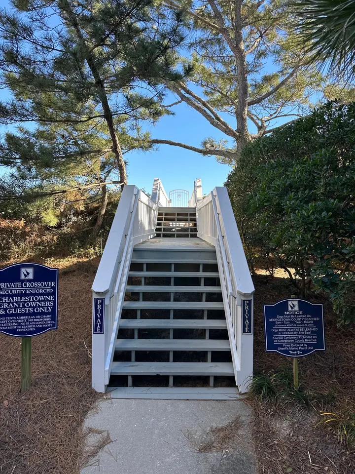 Community-side entrance steps and white railings on a completed Charlestowne Grant walkover