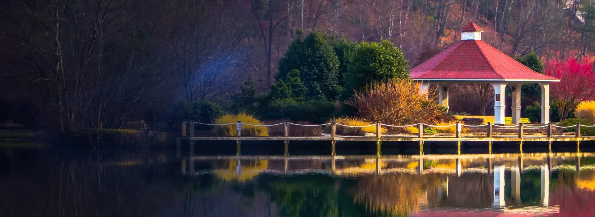 Waterfront gazebo and deck reflected in a calm lake