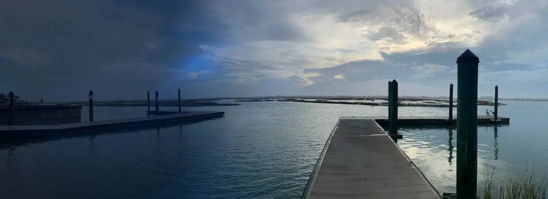 Fixed pier and piling-supported walkway extending into a coastal Myrtle Beach waterway