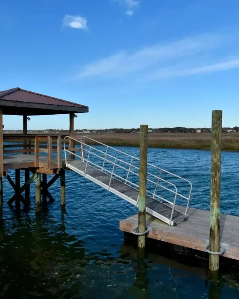 Floating dock connected by an aluminum gangway to a fixed covered pierhead
