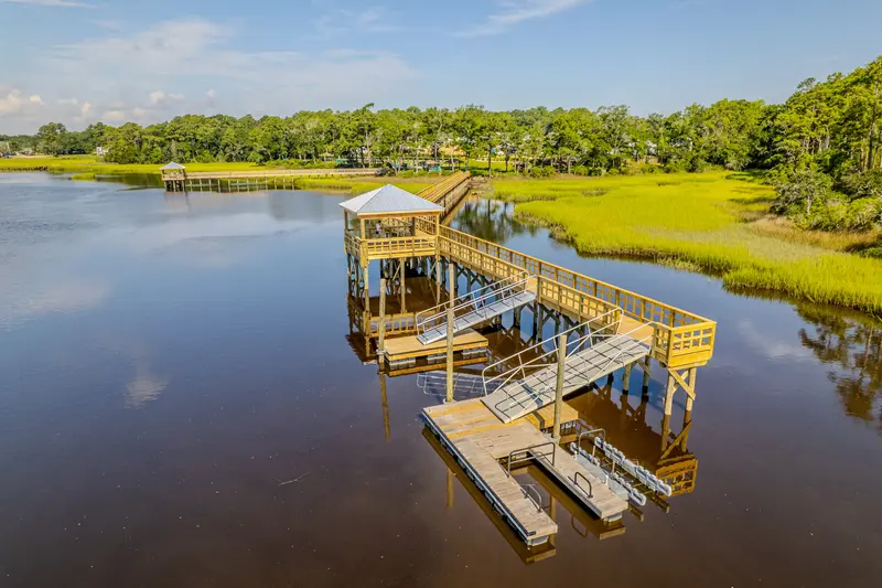 Aerial view of floating docks, aluminum gangways, and a covered pier at Kingfish Bay in Calabash