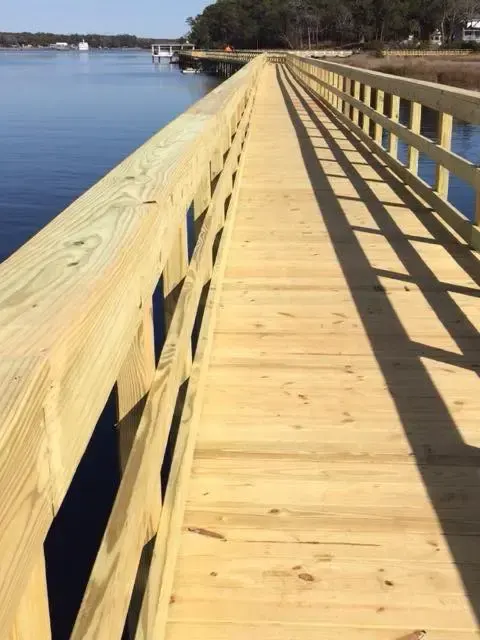 Timber fixed pier walkway with railings at Hope Pointe in Little River