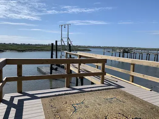 Fixed pier walkway leading to the boat lift over the creek in Murrells Inlet