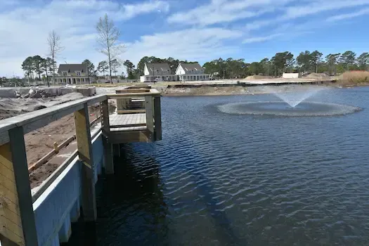Fishing deck projecting from the bulkhead beside the Living Dunes pond