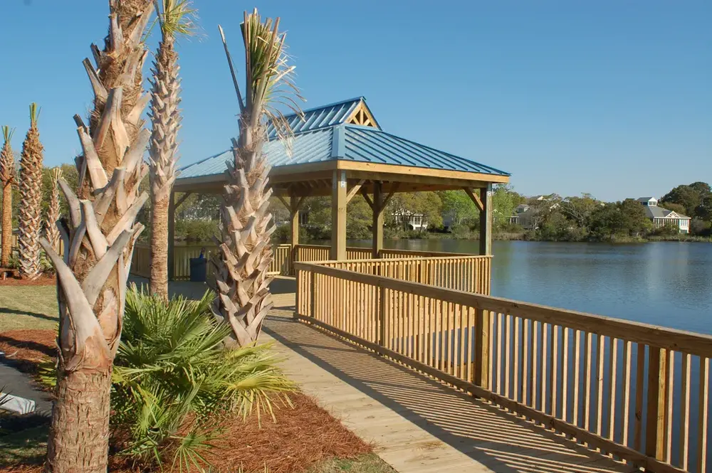 Timber gazebo beside a pond with a connected waterfront walkway