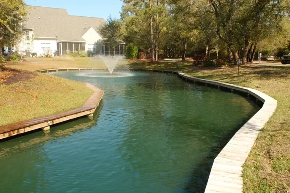 Segmented shoreline wall protecting a residential pond edge