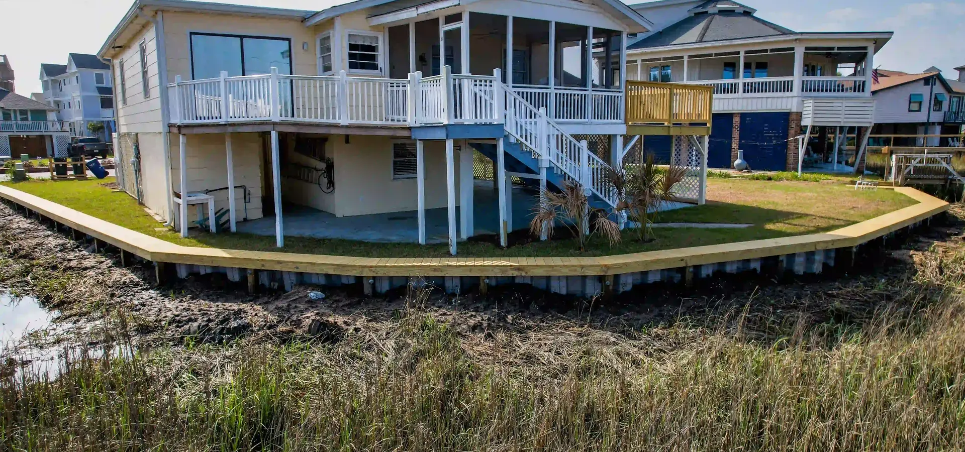 Completed vinyl bulkhead and timber cap at a Pawleys Island waterfront home