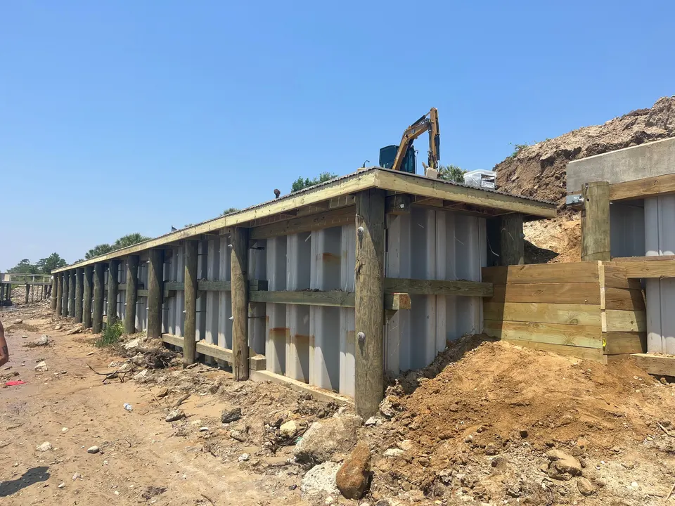 Vinyl seawall face, timber framing, and cap assembly during construction in Grande Dunes