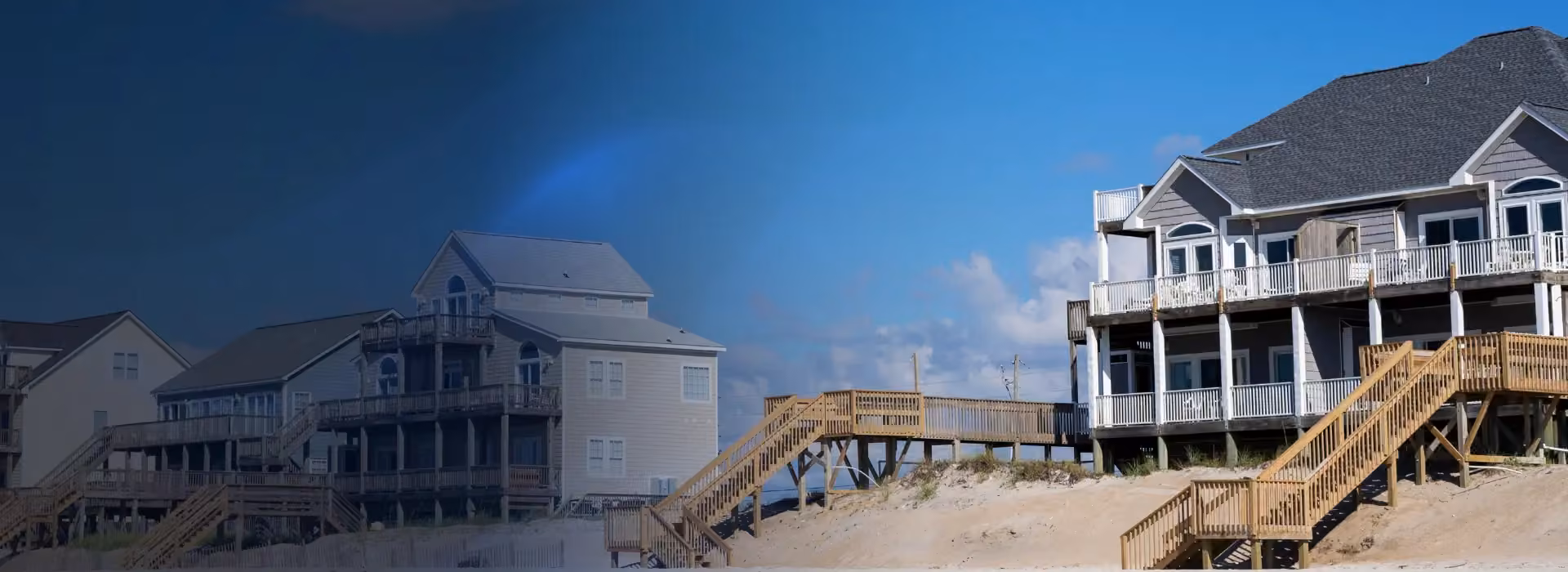 Oceanfront homes connected by wooden dune walkovers